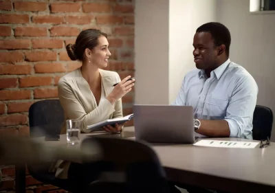 Happy business colleagues cooperating while working